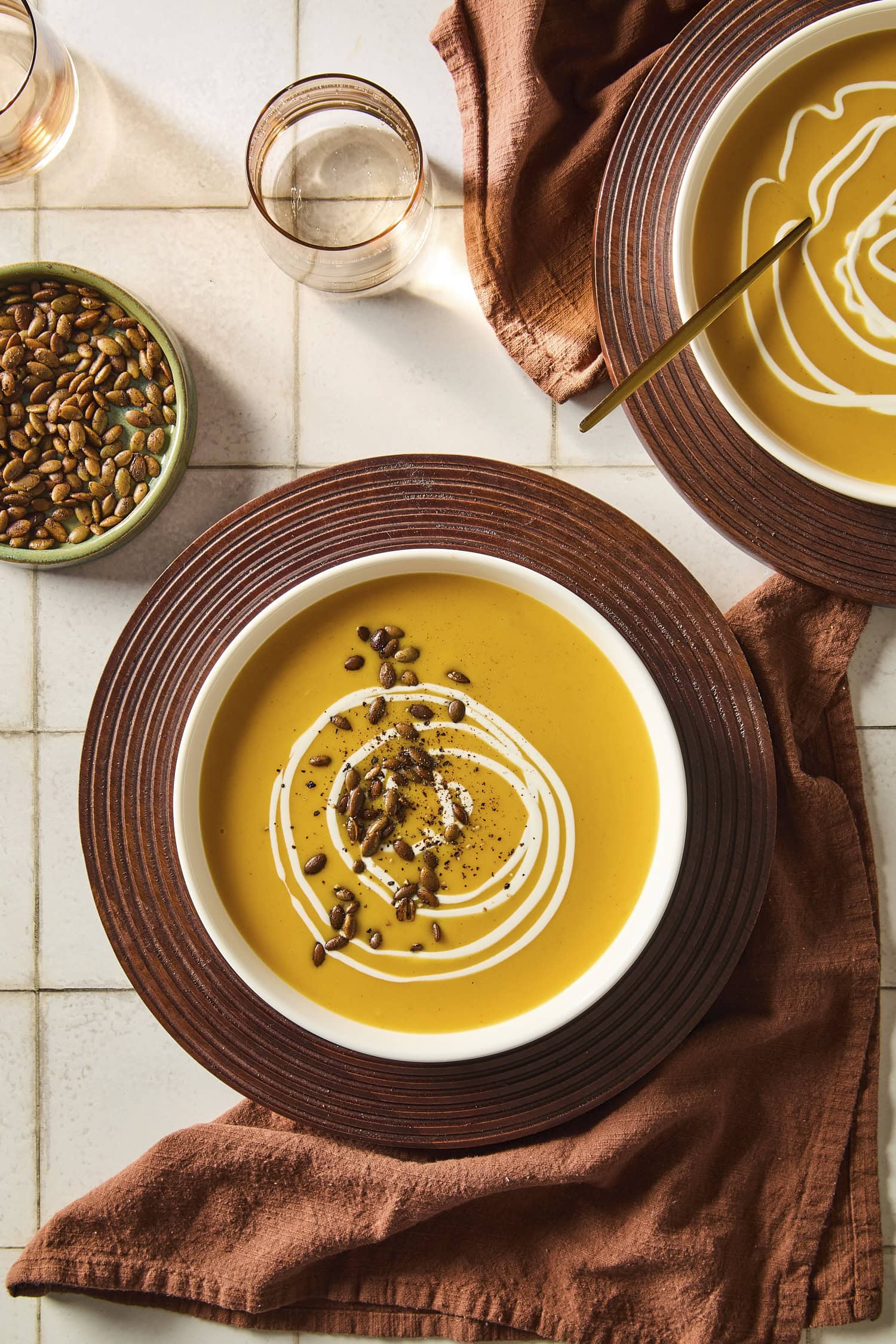 Harvest squash soup topped with roasted pepitas and heavy cream.