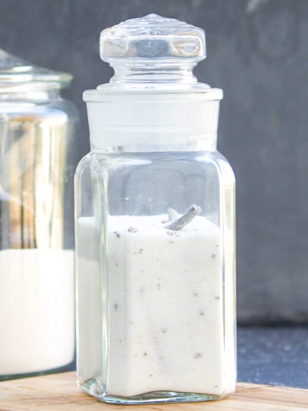 A jar full of vanilla sugar on a table.