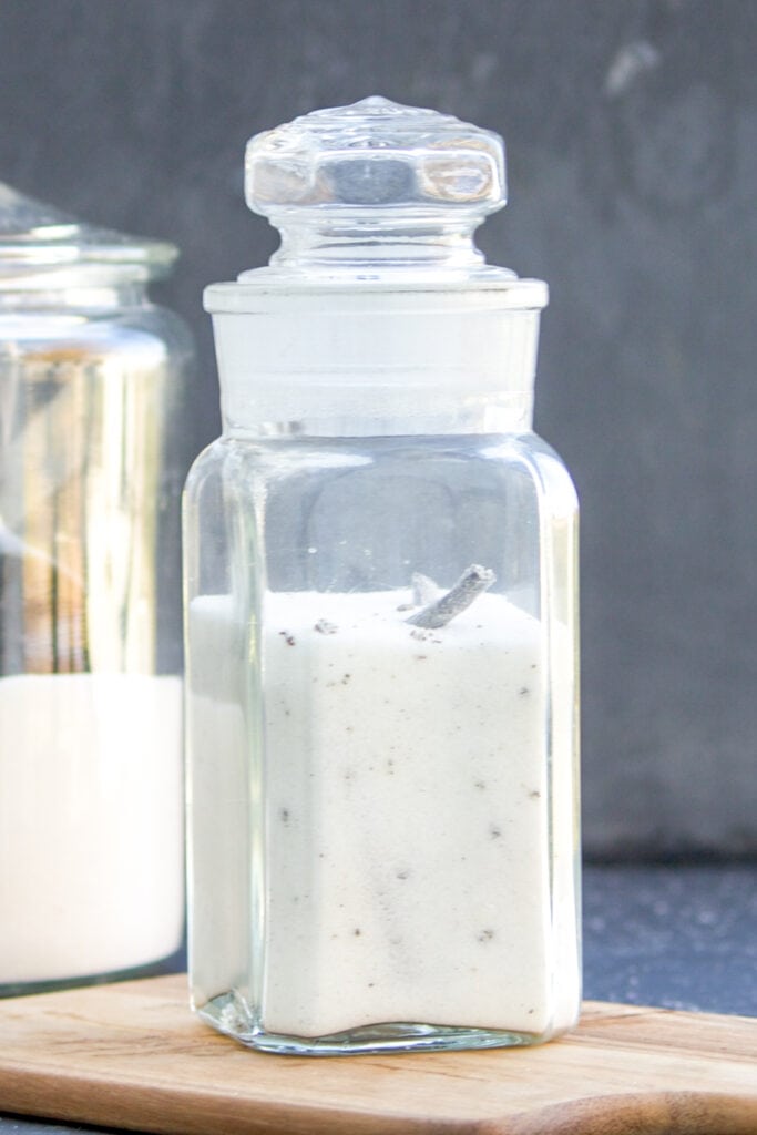 A jar full of vanilla sugar on a table.