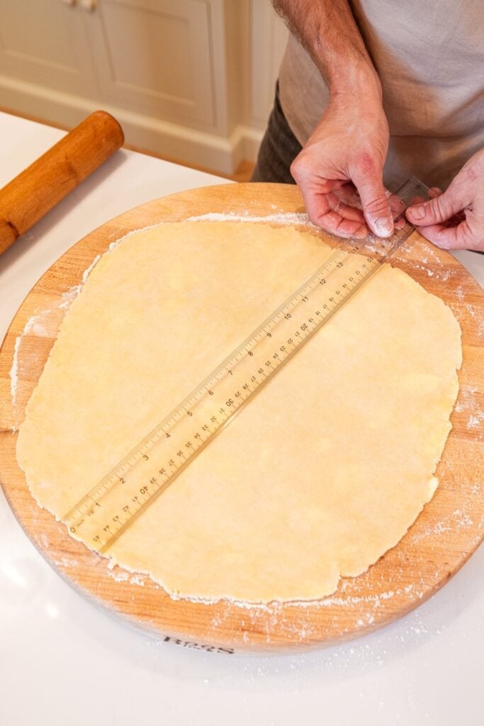 Ruler measuring size of pie dough for a galette.