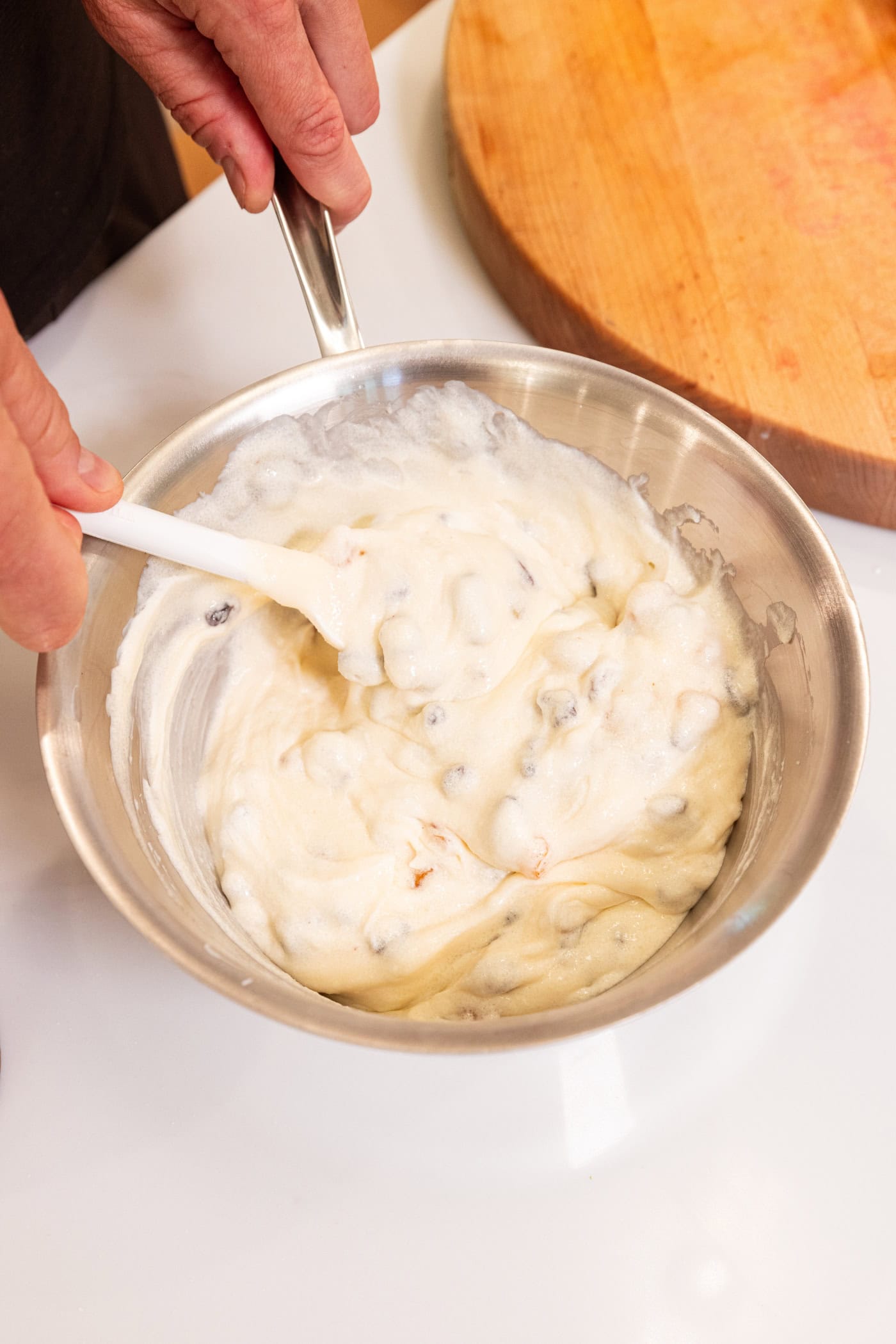 Metal saucepan with mixture of sour cream raisin pie filling inside.