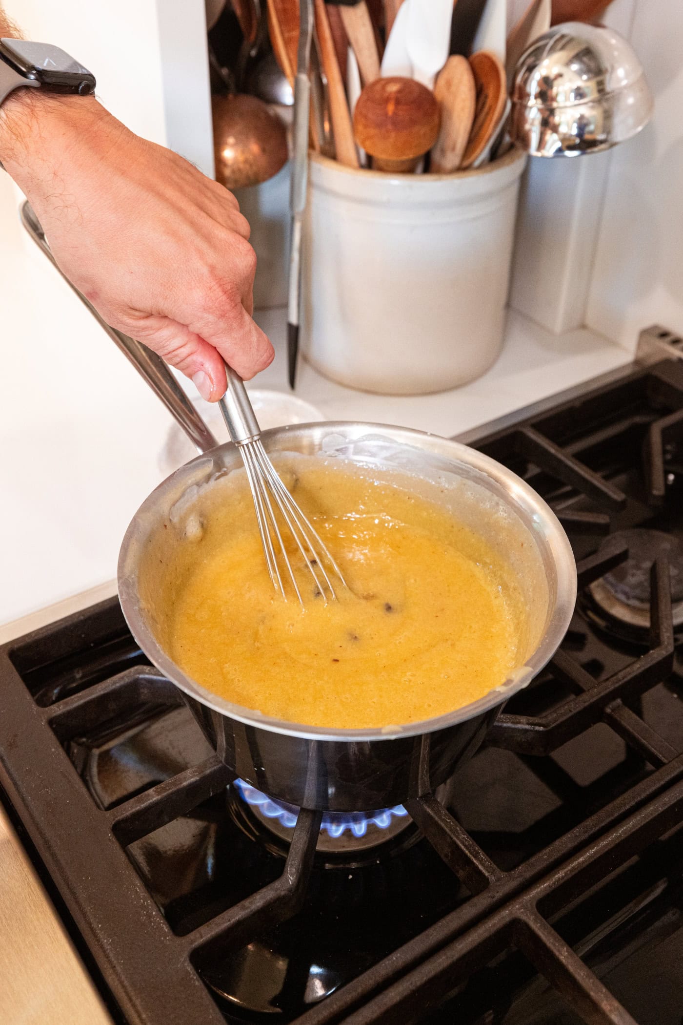 Yellow-colored raisin pie filling heating on the stovetop.