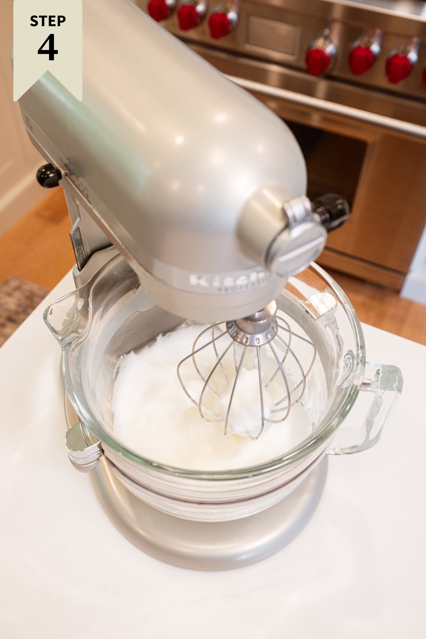 Stand mixer mixing together fluffy egg whites for meringue topping.