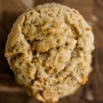 Top down view of light brown crunchy peanut cookies sitting on a wood cutting board