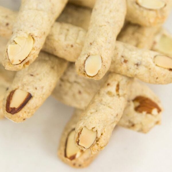 Criss crossed finger cookies made in a finger shape with an almond as a nail.