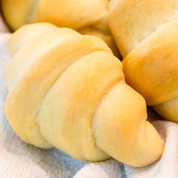 Golden butter horns sitting on white towel