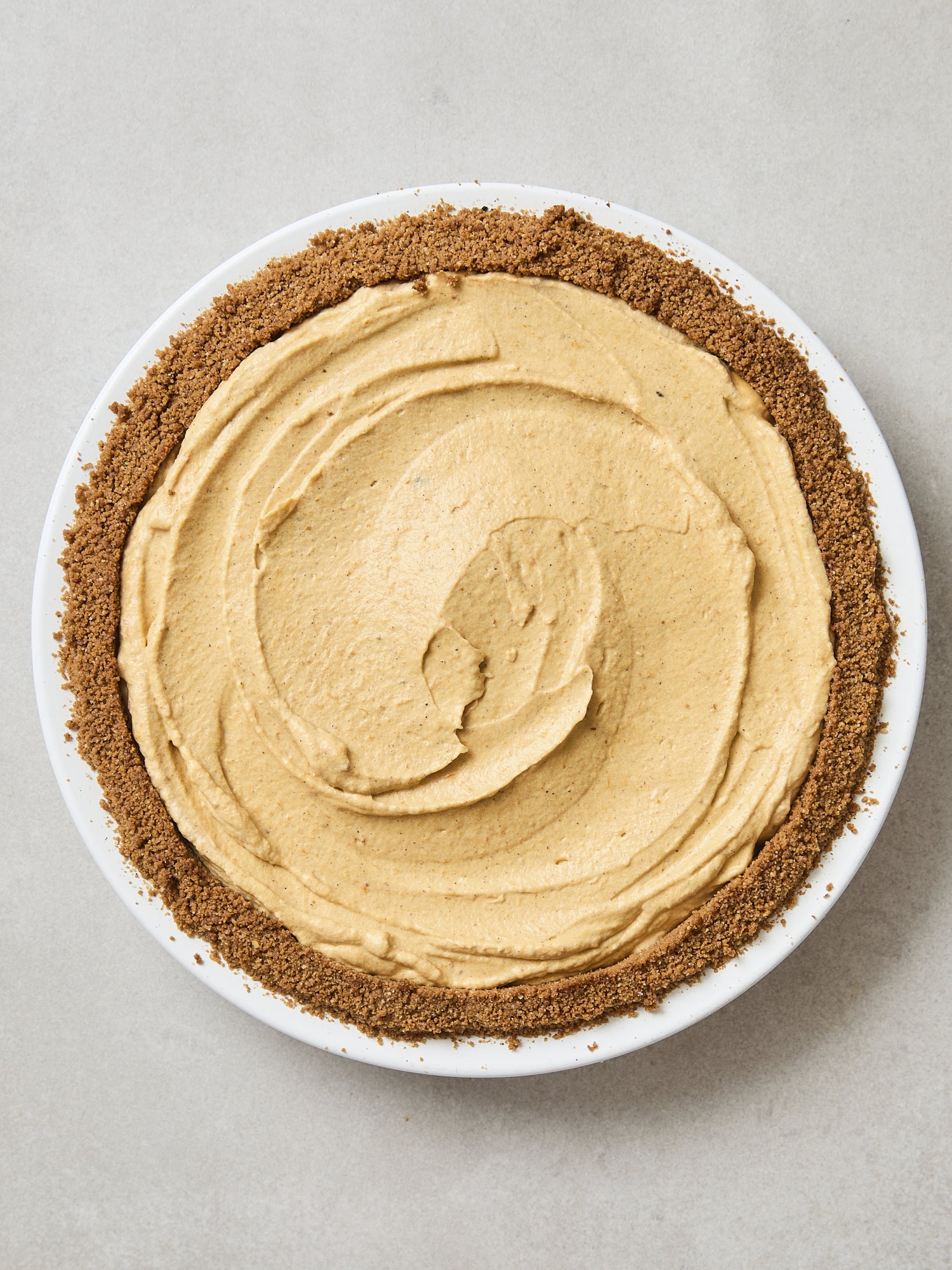 Smoothed frozen pumpkin cheesecake in a gingersnap crust.