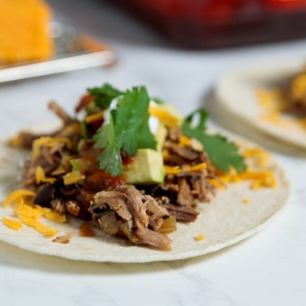 Flour tortilla with carnitas meat cooked in the slow cooker.