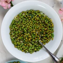 White bowl filled with herb and vinaigrette peas
