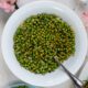 White bowl filled with herb and vinaigrette peas