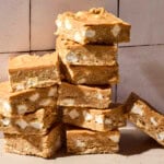Stacks of butterscotch bars on countertop with a smooth topping.