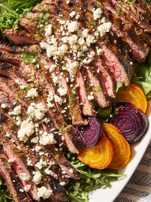 Steak salad with crumbled blue cheese and green dressing and beets.