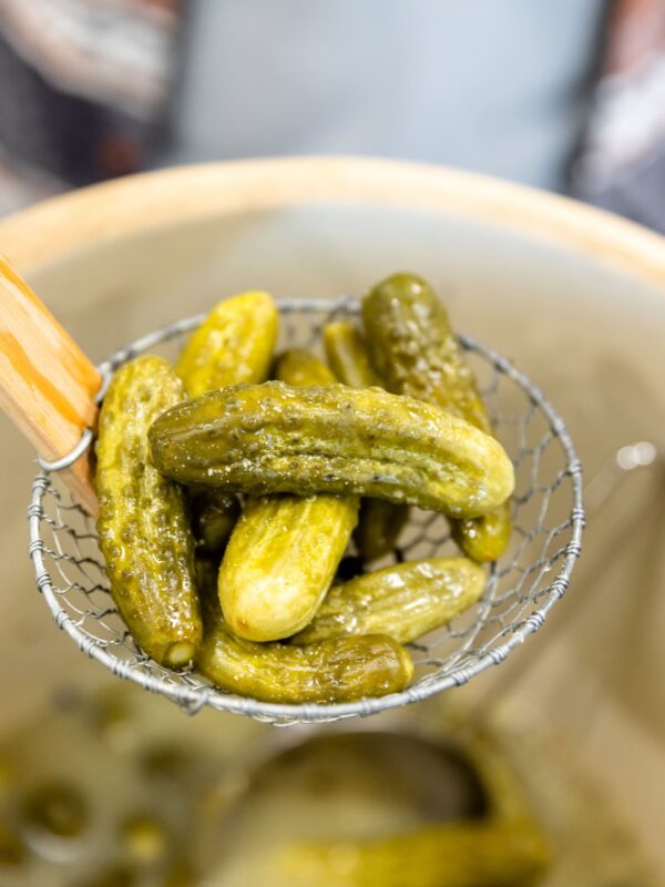 Spider filled with a ladle full of mustard pickles before being placed in jars.