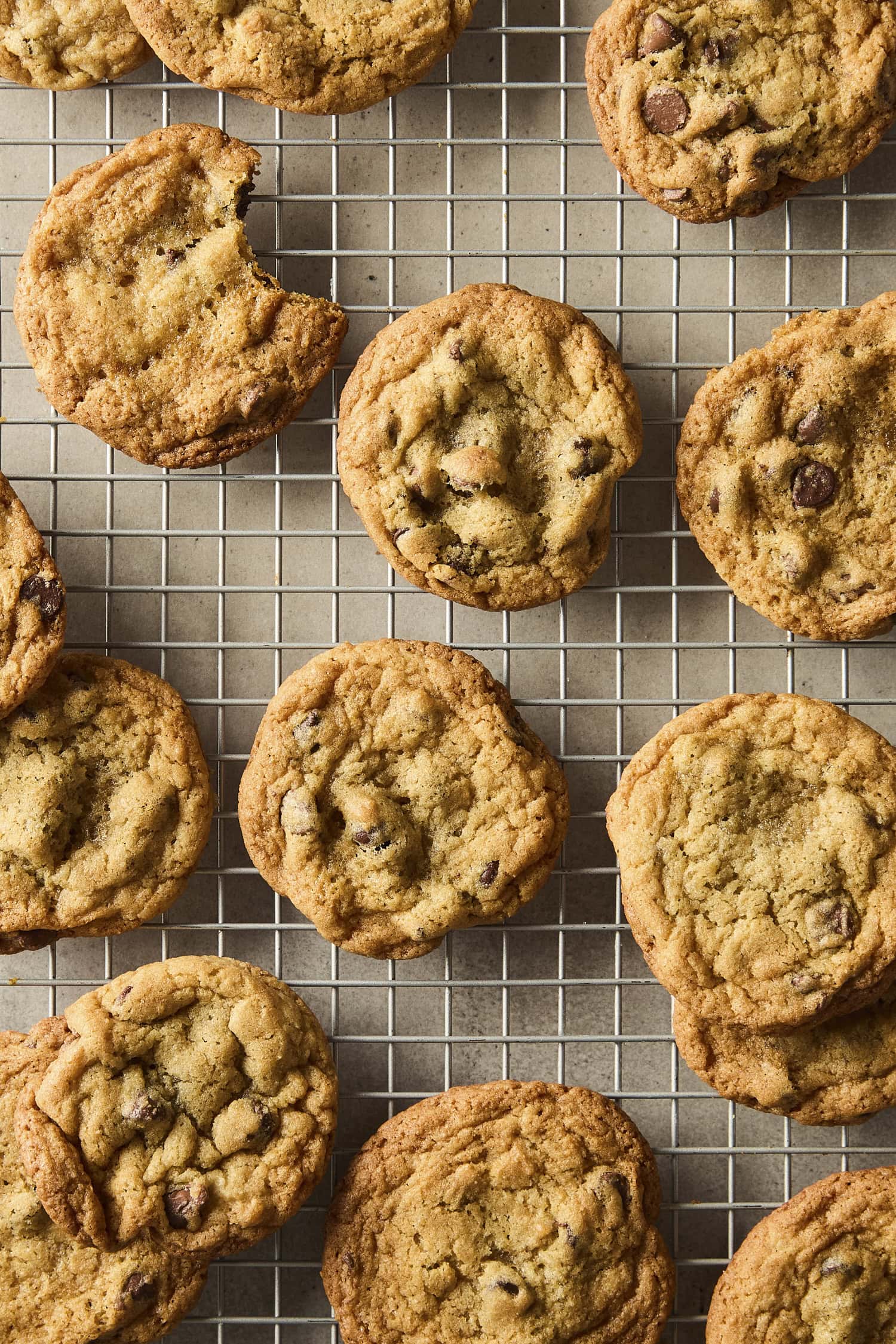 Cooling chocolate chip cookies on a cooling rack.