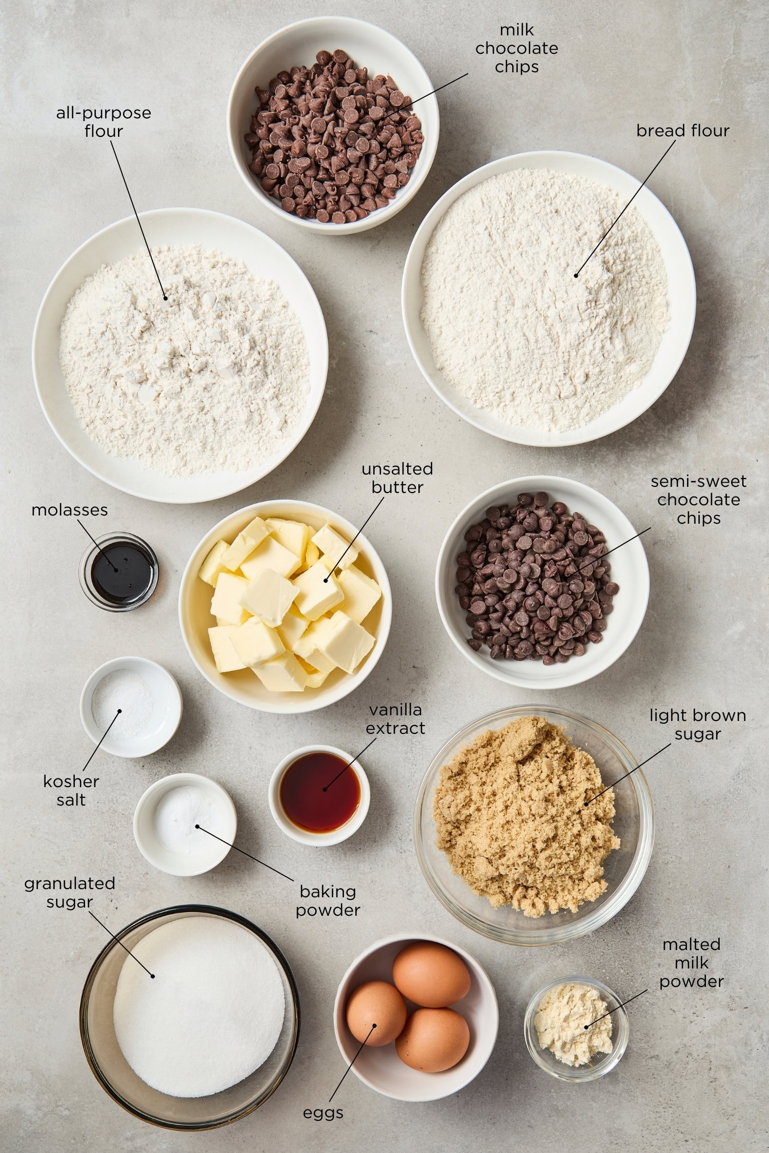 Concrete surface with ingredients needed for chocolate chip cookies.