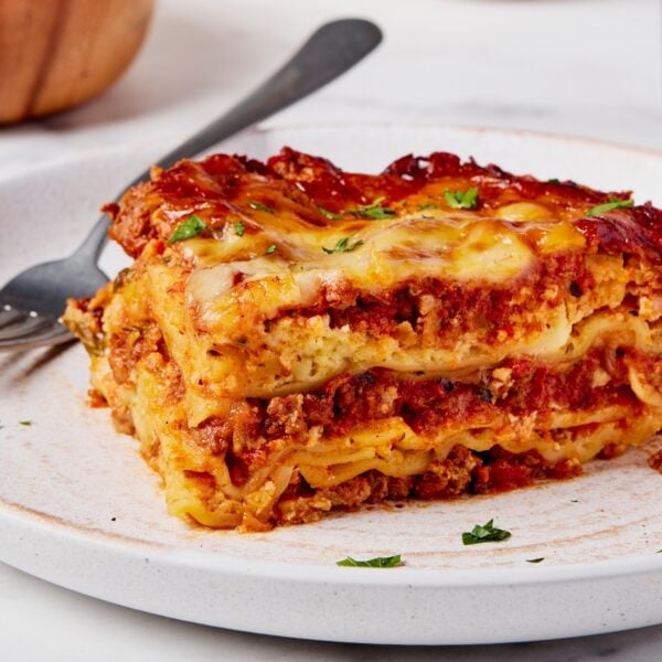 Piece of lasagna on a plate showing interior layers.