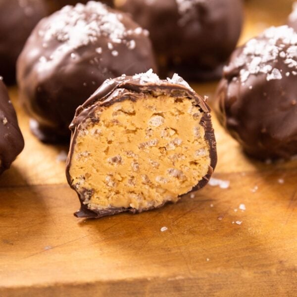 Peanut butter ball cut in half sitting on wood board