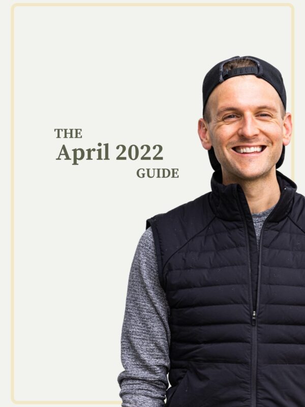 Kaleb Wyse wearing black best with ball cap on backwards standing in front of taupe background with words stating the month and year.