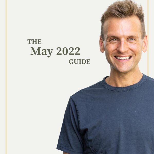 Kaleb Wyse wearing blue shirt standing in front of taupe background with the words "The May 2022 Guide".