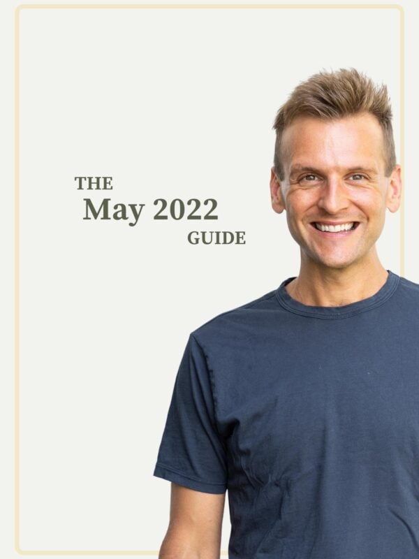 Kaleb Wyse wearing blue shirt standing in front of taupe background with the words "The May 2022 Guide".