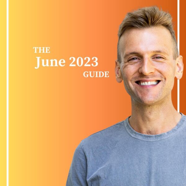 Kaleb Wyse wearing blue shirt standing in front of gradient yellow and orange background.