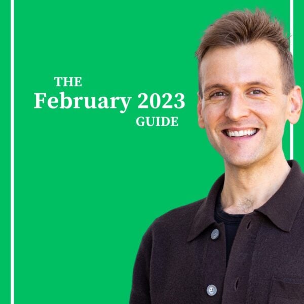 Kaleb Wyse wearing dark gray buttoned shirt standing in front of green background.