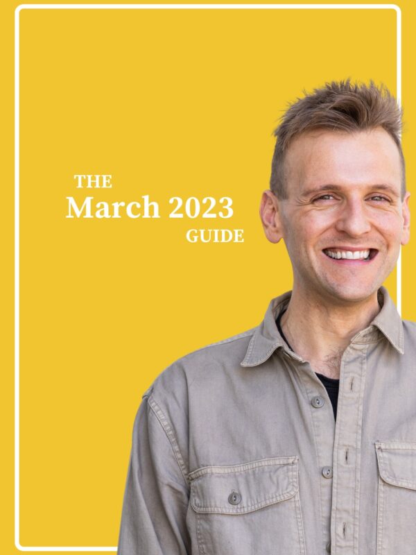 Kaleb Wyse wearing brown button down shirt standing in front of bright yellow background with the words "The March 2023 Guide".