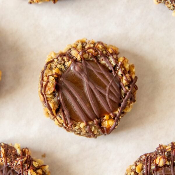 Small cookies lay flat on parchment paper.