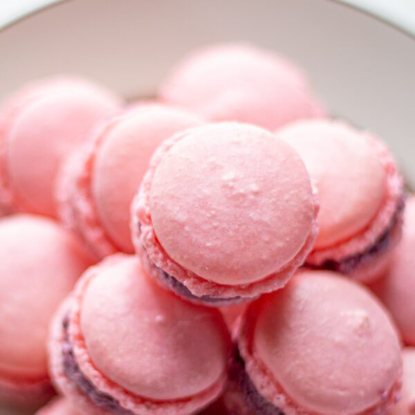 A tower of macarons on a plate.