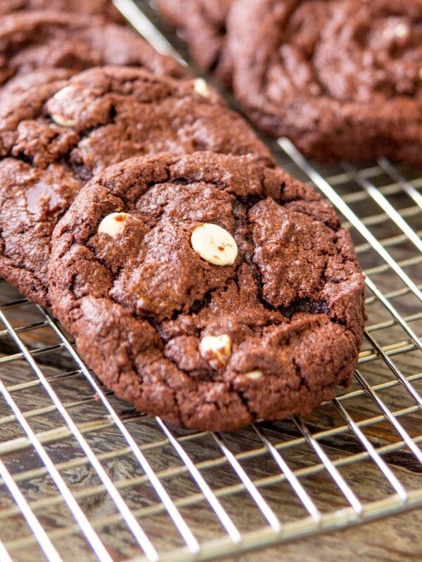 Chocolate cookies rest on a cooling rack.