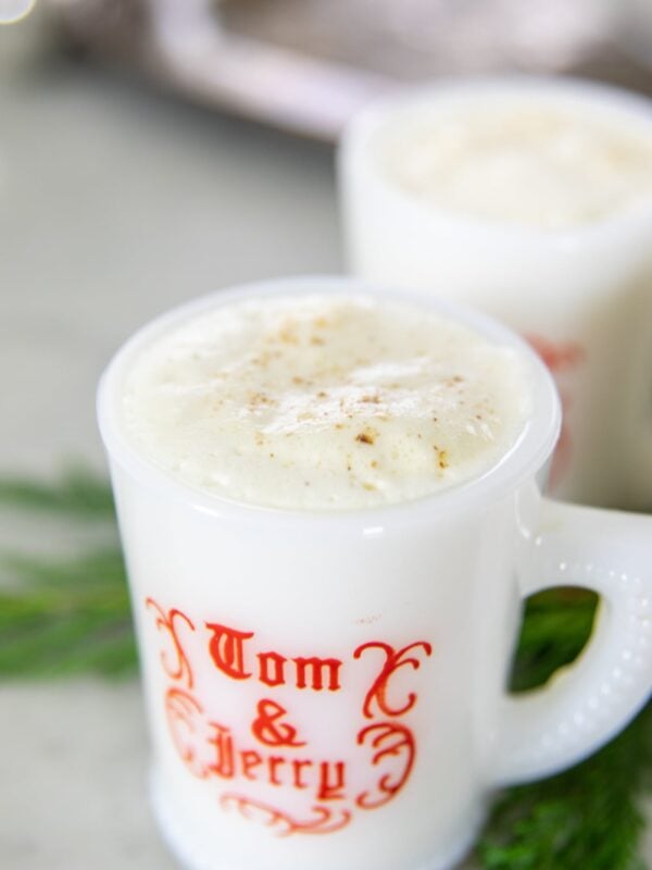 Eggnog rests in a coffee cup on a table.