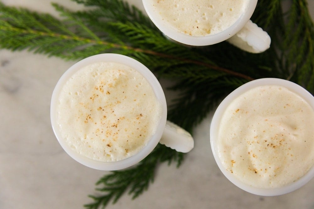 Eggnog fills three mugs.