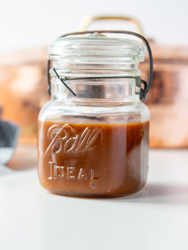 A small jar full of homemade caramel.