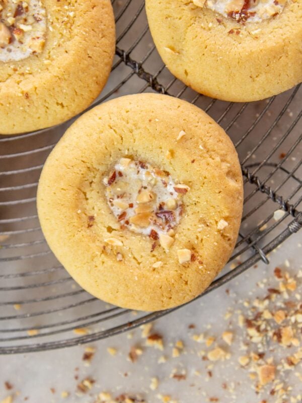 A cookie topped with honey butter and almond pieces.