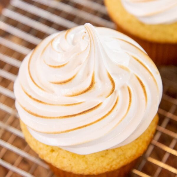 Toasted meringue frosting adorns a lemon cupcake.