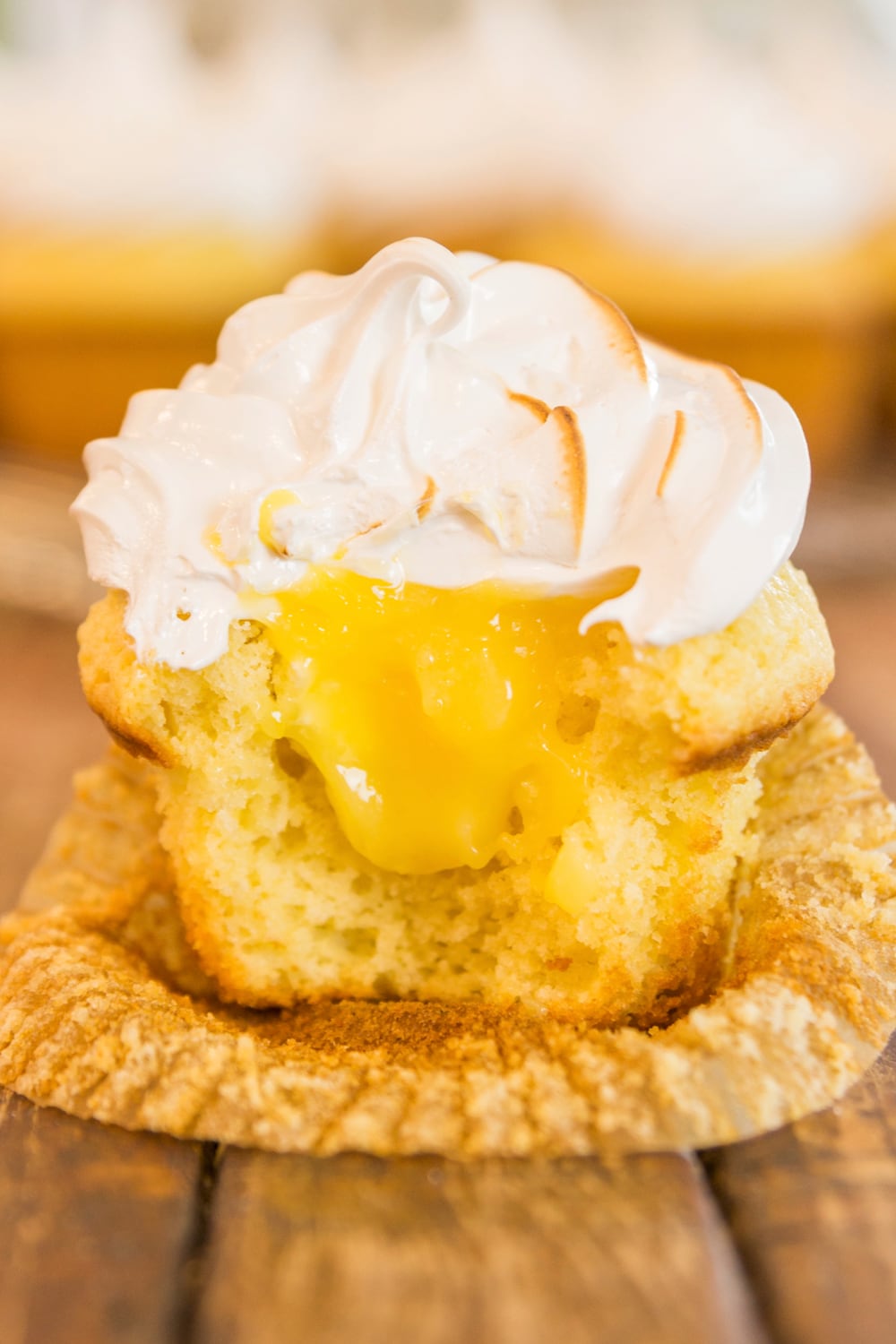 A crosscut section of a cupcake shows filling within.