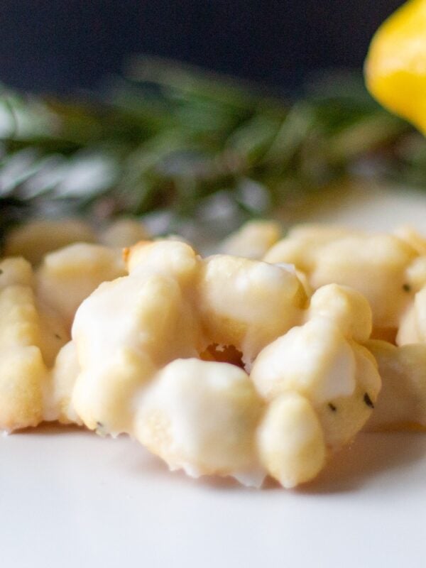 Tea cookies sit in a pile on a table.