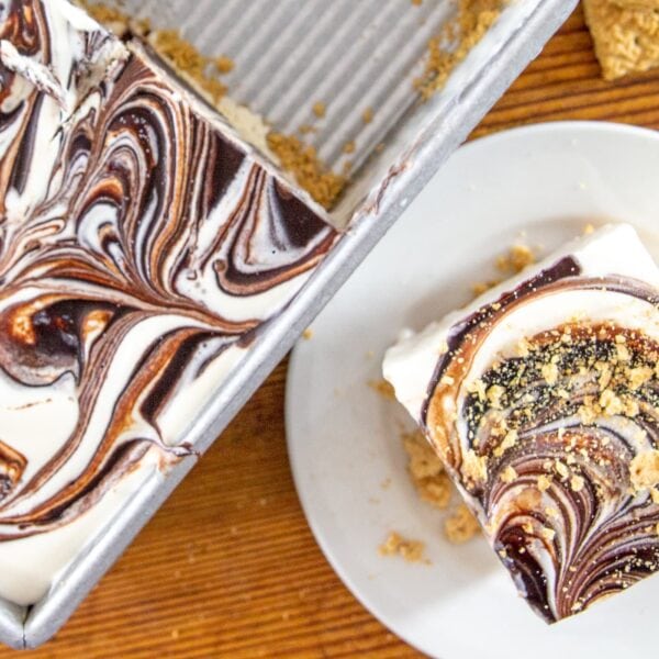 A slice of a no-bake cake rests next the cake it was taken from.