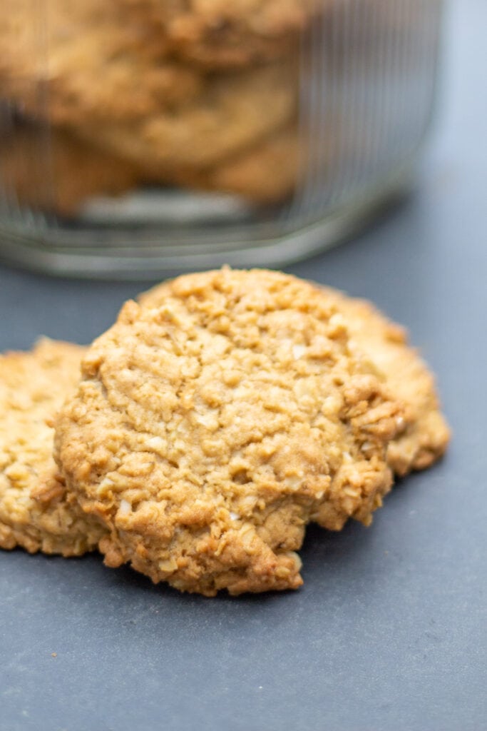 An oatmeal cookie sits on a table.