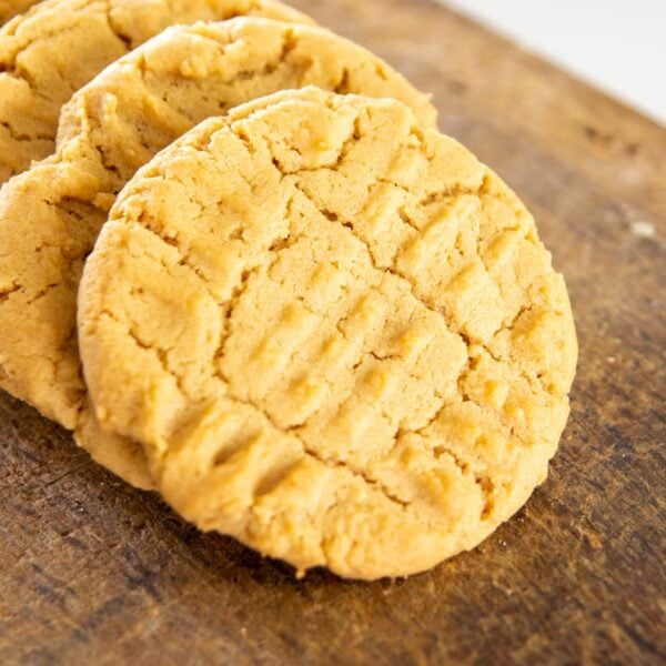Cookies overlap each other in a row on a wooden block.