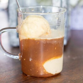 An affogato in a mug sits on a table.