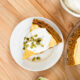 A slice of pumpkin pie cheesecake sits on a table.