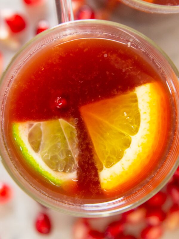 Lime and lemon wedges float in pomegranate punch.