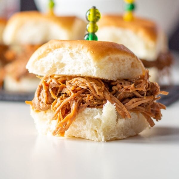 A pulled pork slider sits on a table.