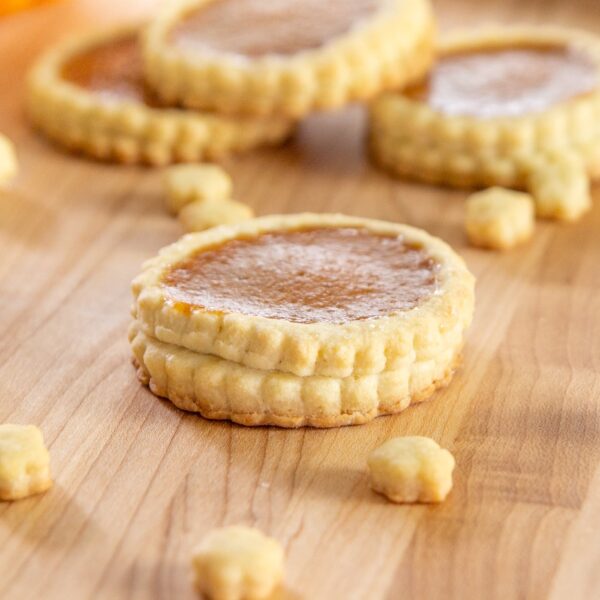 A pumpkin pie cookie rests on the table.