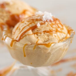 A scoop of ice cream covered in caramel and salt.