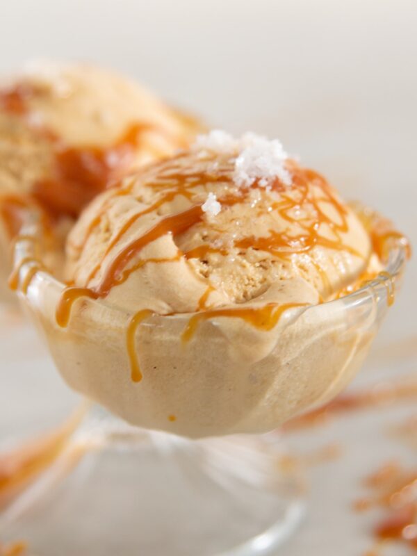 A scoop of ice cream covered in caramel and salt.