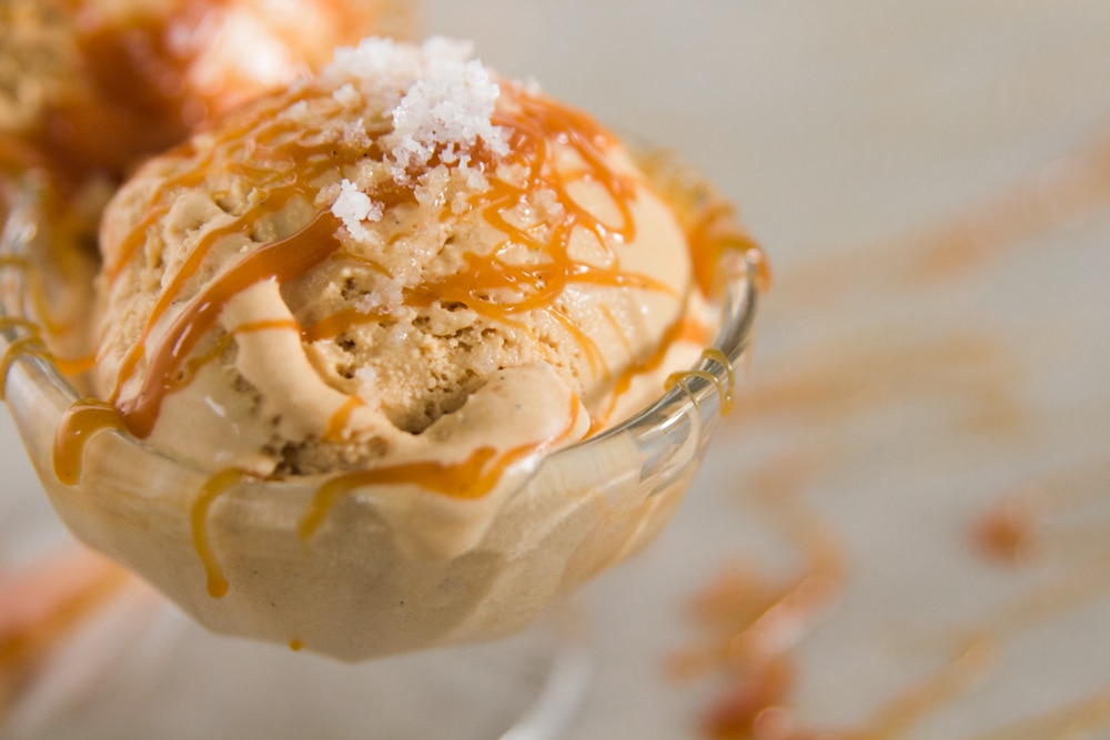 A scoop of caramel ice cream in a dish.