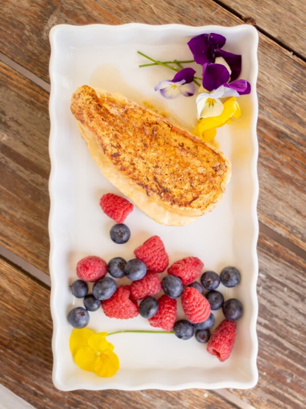 Stuffed French toast with berries sits on a plate.