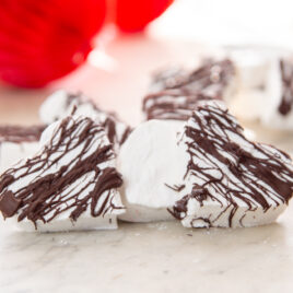 Two heart-shaped marshmallow treats sit on a table.
